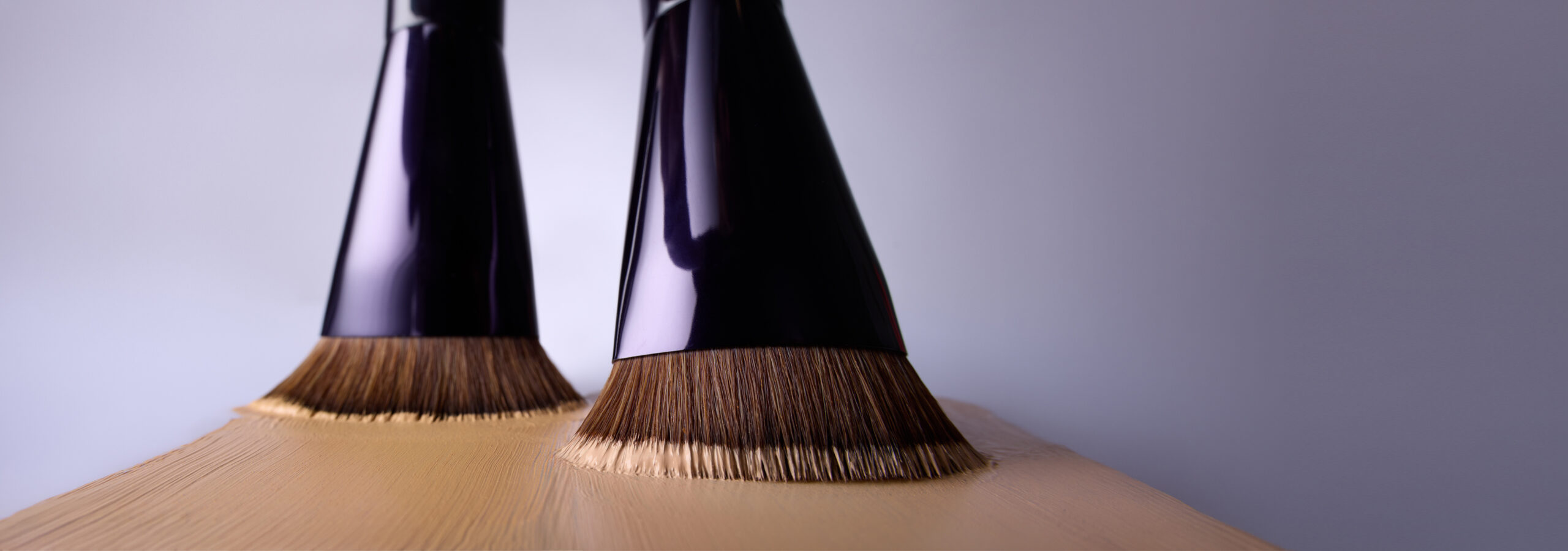 Close-up makeup brushes applying product